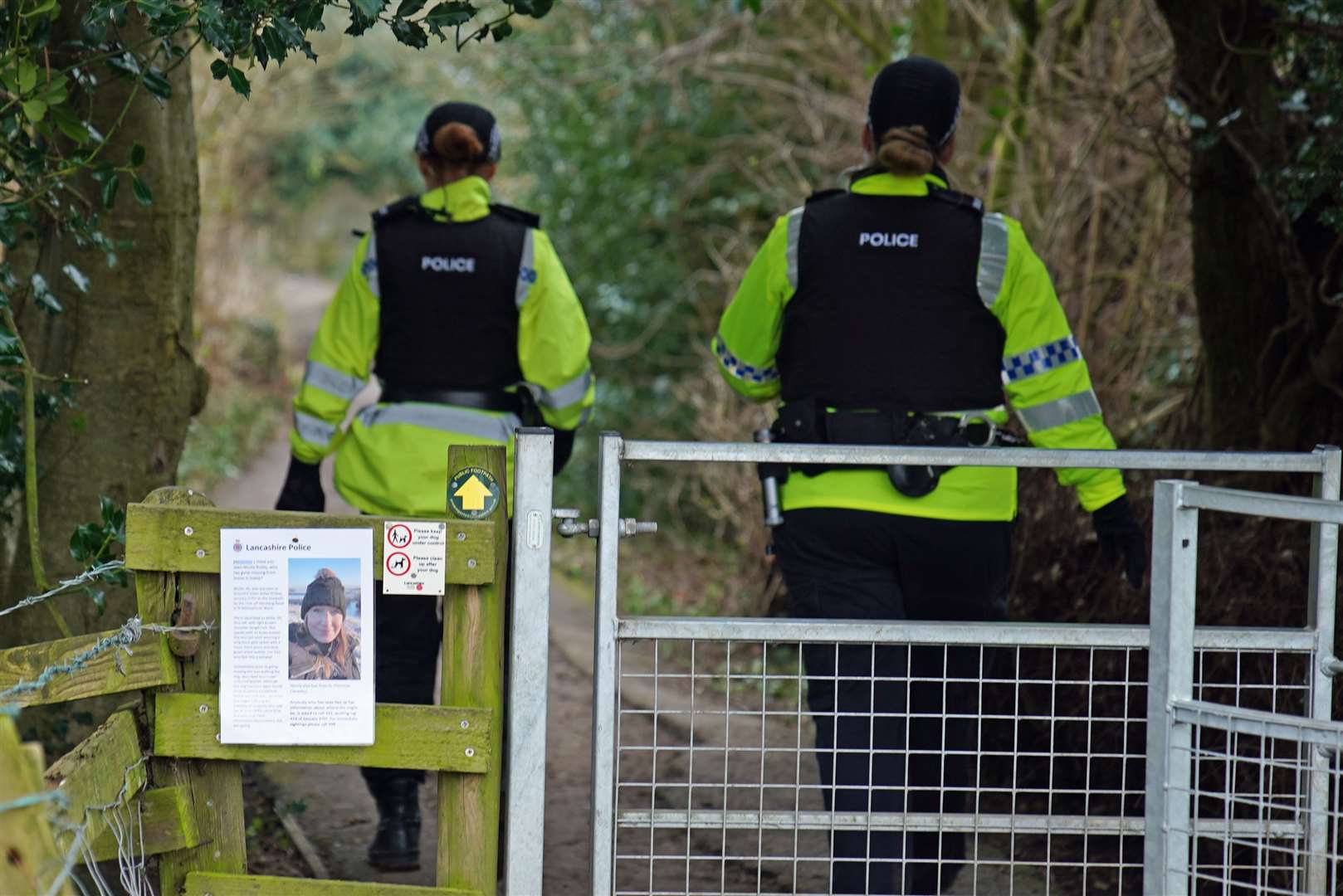 Police officers walk along a footpath in St Michael’s on Wyre as they continue their search for missing mother-of-two Nicola Bulley (Peter Byrne/PA)