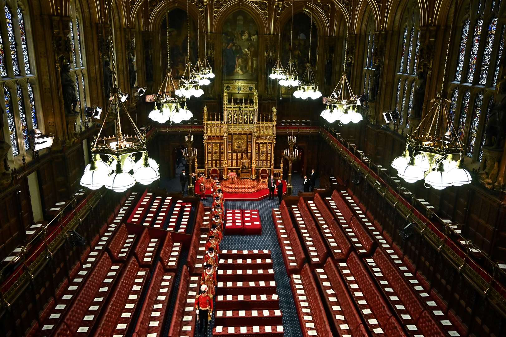 Yeomen of the Guard walk among the seats in the House of Lords Chamber (Ben Stansall/PA)