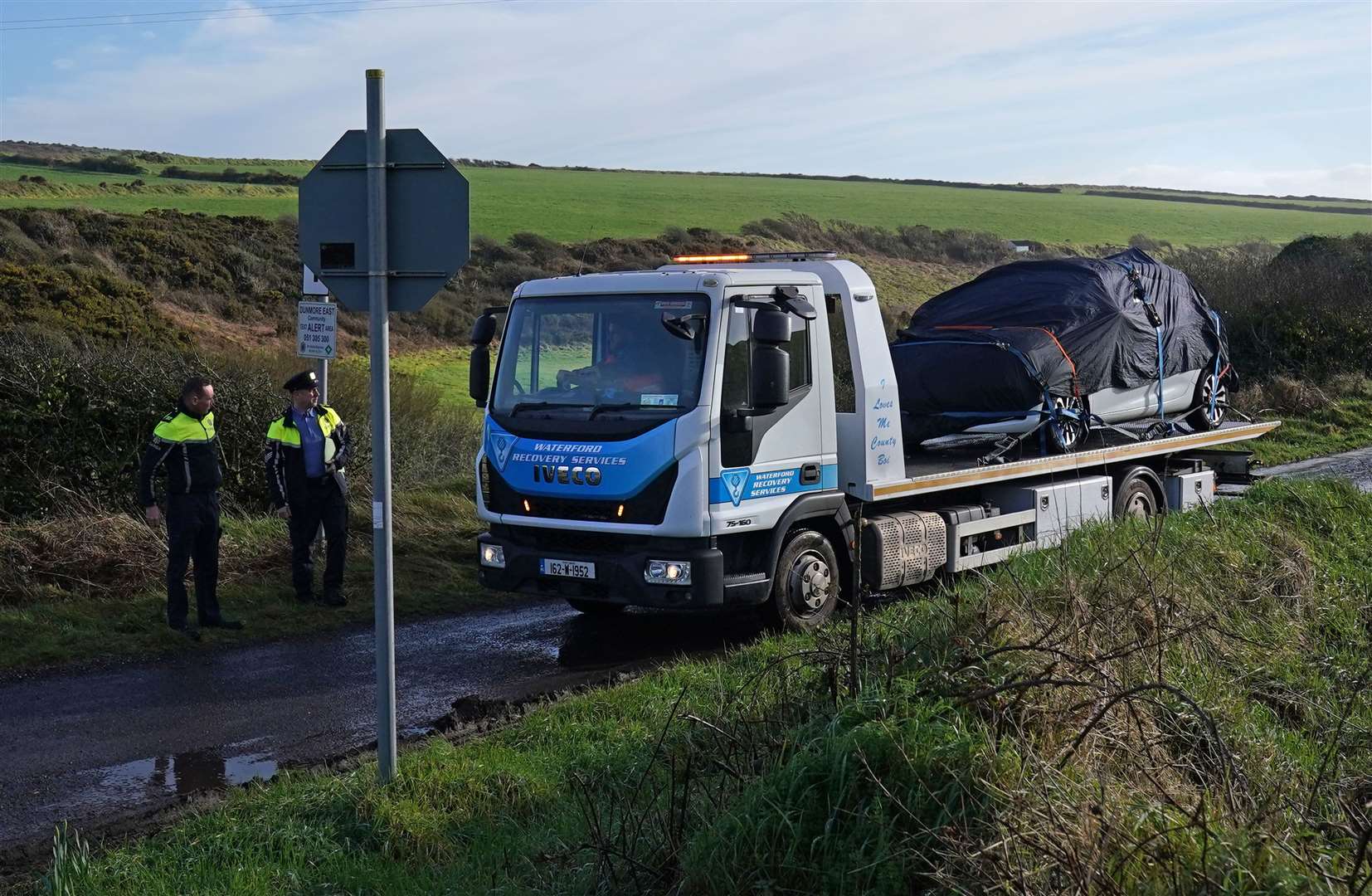 A car is removed from the Rathmoylan area of Dunmore East, Co Waterford, where police are investigating the death of a six-year-old boy whose body was found in a car (Brian Lawless/PA)