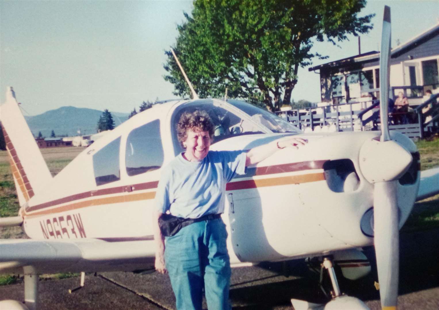 Ms Buckland next to her cousin’s Piper PA-28 Cherokee plane (Care UK/PA)