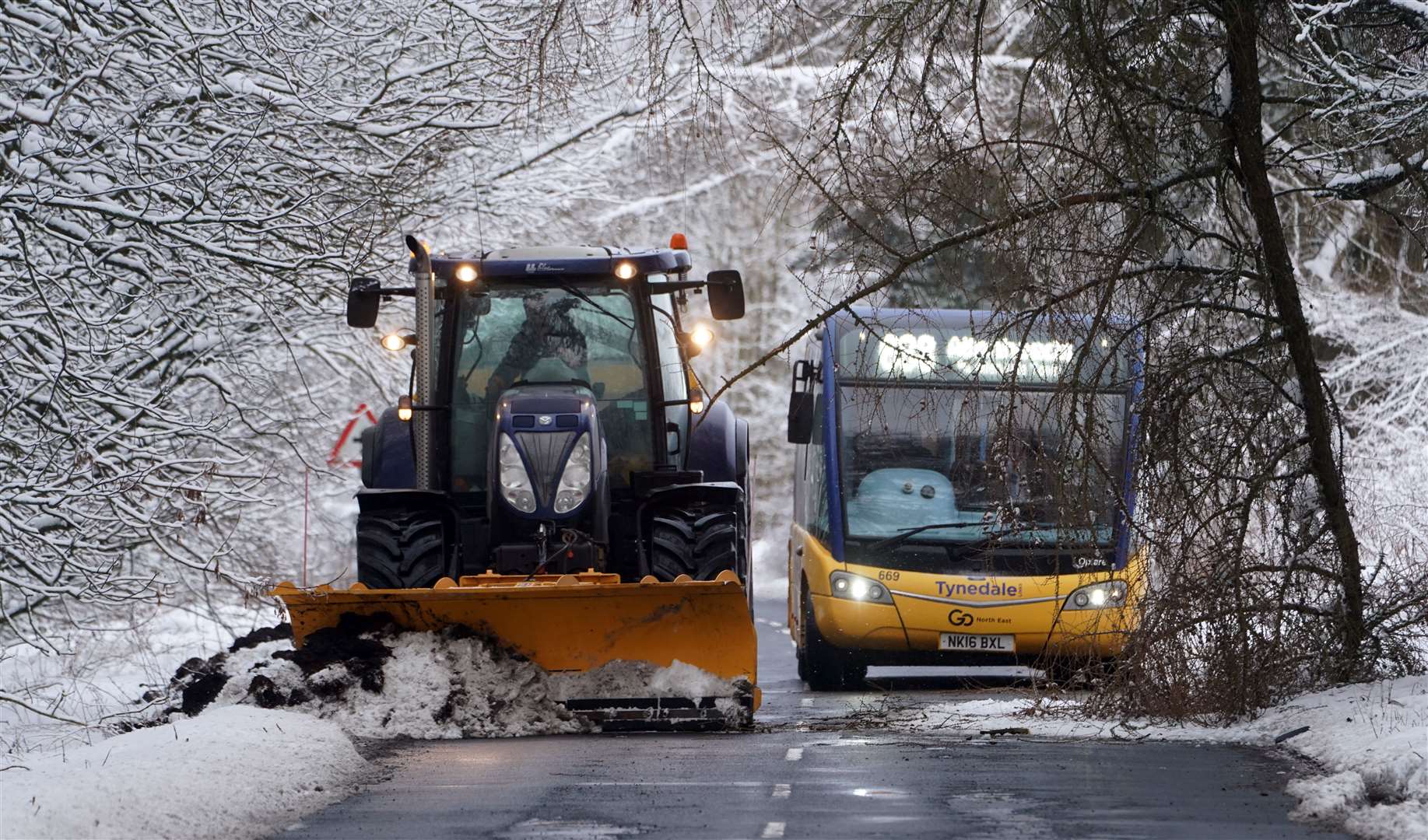 A tractor clears snow on a road in Allenheads, Northumberland (Owen Humphreys/PA)