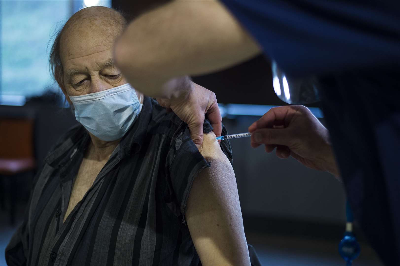 A patient receives the first of two injections with a dose of the Pfizer/BioNtech Covid-19 vaccine (Kirsty O’Connor/PA)