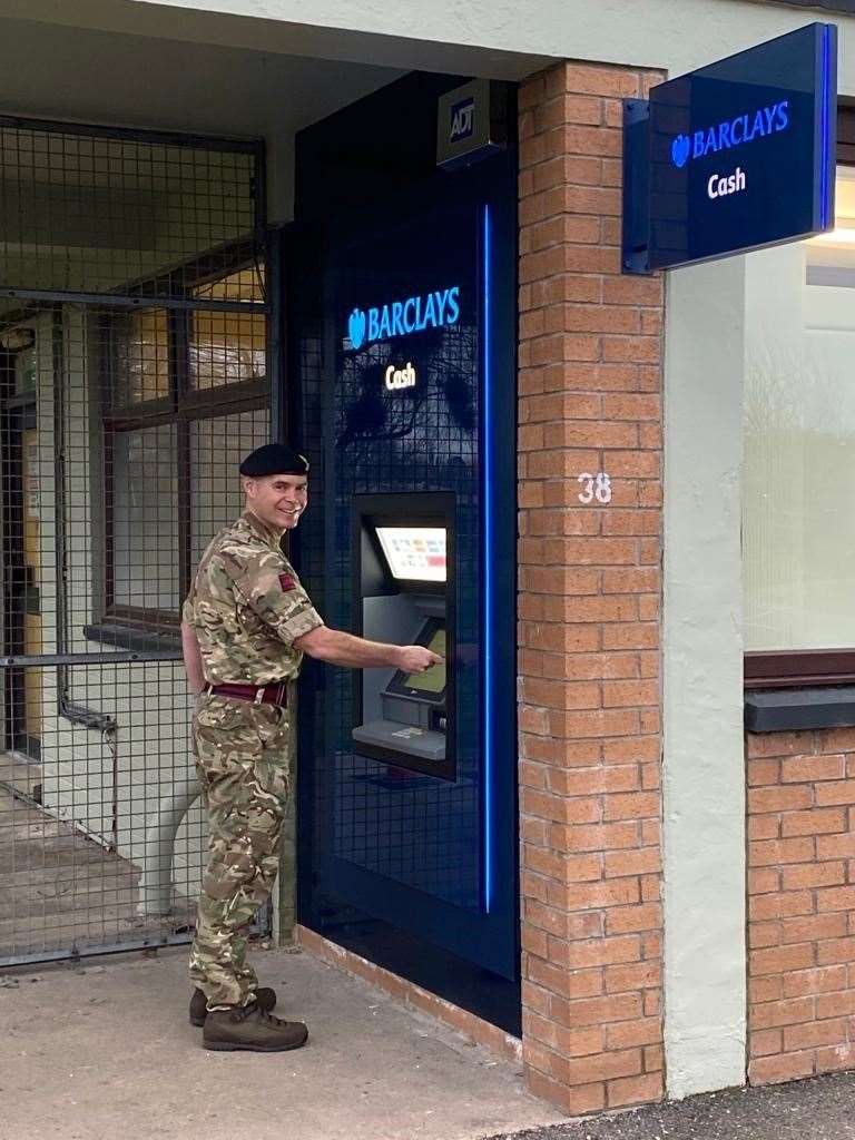 A Kinloss Barracks serviceman using the new ATM installed at the guardhouse.