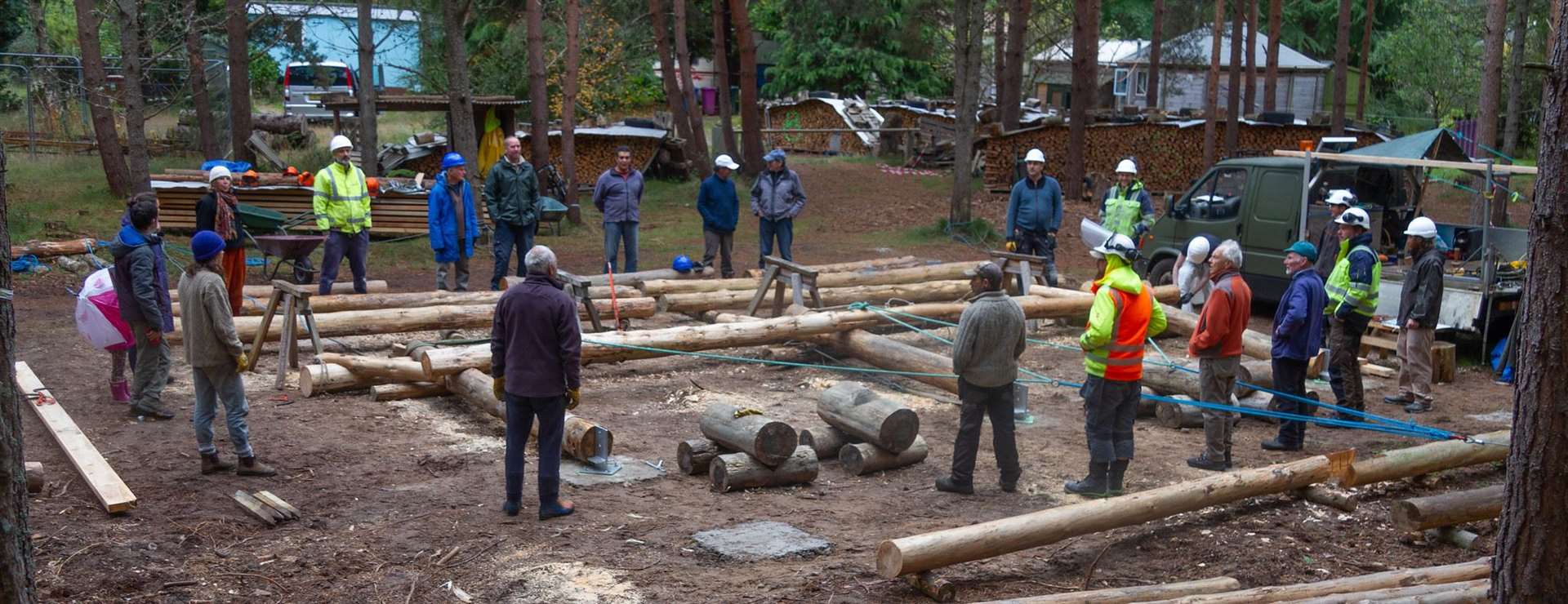 Gathering to help raise the first large wooden frame onto the foundations. Picture by Hugo V.M. Klip