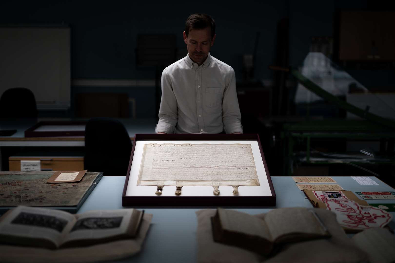 Laurence Ward, of the London Metropolitan Archives, holds a 1613 William Shakespeare property deed from Blackfriars (Aaron Chown/PA)