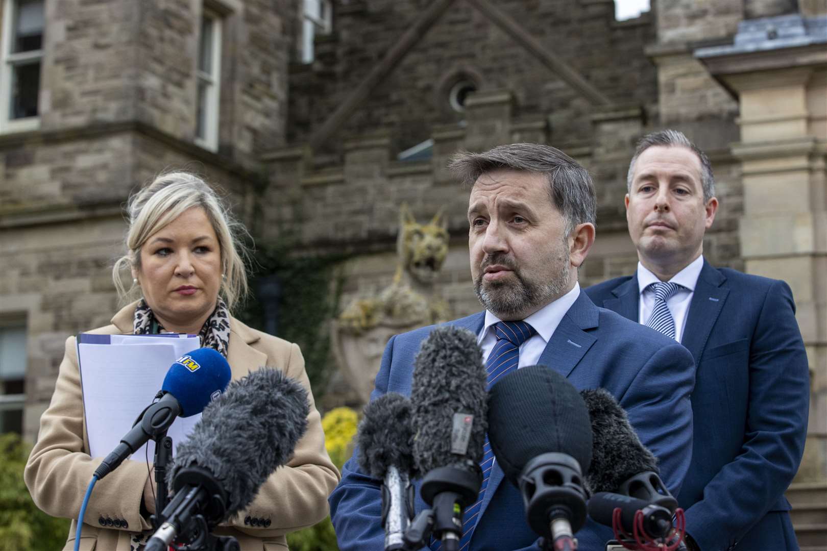 Northern Ireland Minister of Health Robin Swann (centre) speaks during a press conference at Stormont Castle in 2021, as he gave an update from the Northern Ireland Executive on new Covid measures as then deputy First Minister Michelle O’Neill (left) and then First Minister Paul Givan (right) look on (PA)