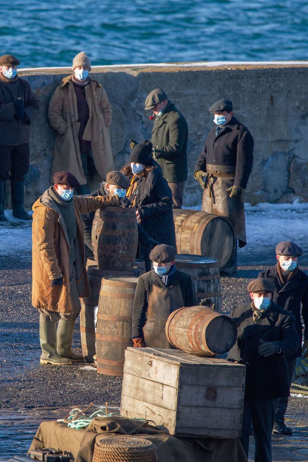 The 1930s mixed with 2021 as extras wear Covid protective masks during filming in Portsoy last February. Picture: Daniel Forsyth