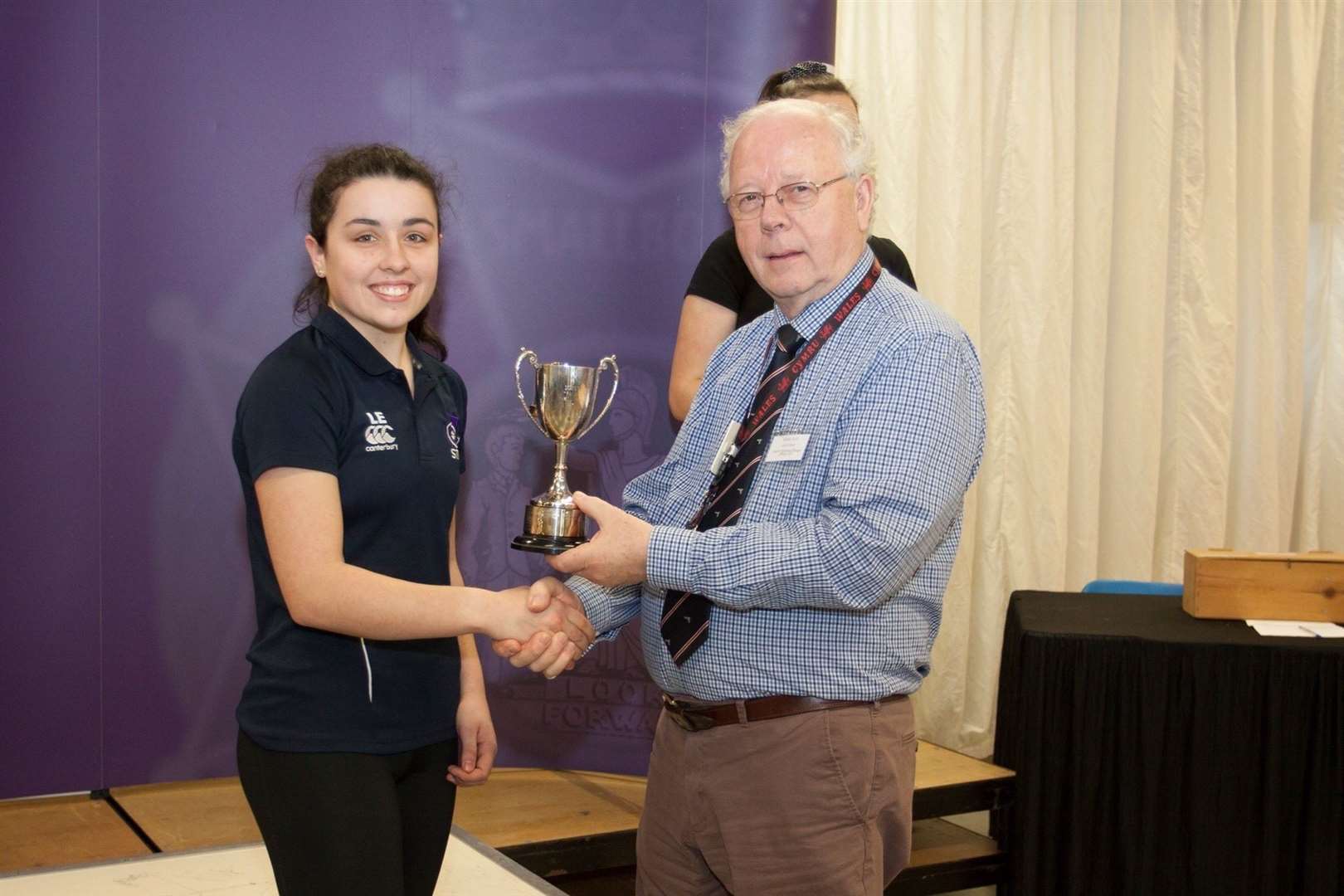 Forres shooter Lucy Evans receiving her trophy from John Lloyd, chairman of the NSRA.