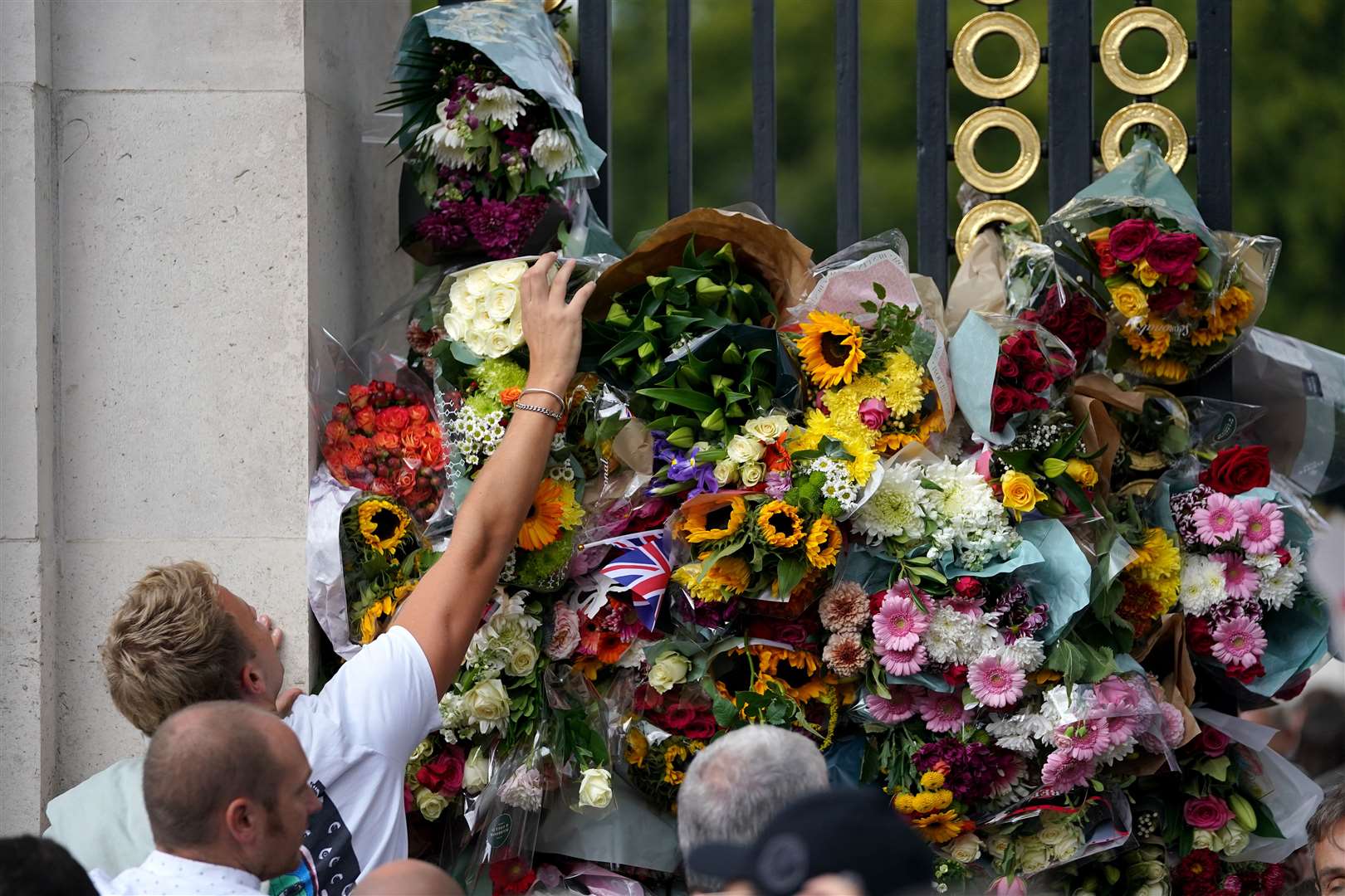 Flowers are placed outside of Buckingham Palace (Zac Goodwin/PA)