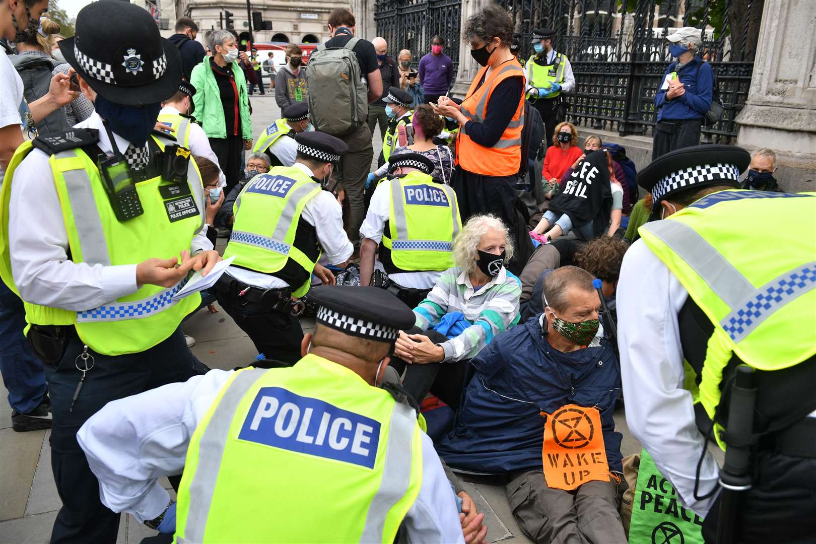 Police speak to protesters at the Carriage Gates entrance to the Houses of Parliament (Dominic Lipinski/PA)