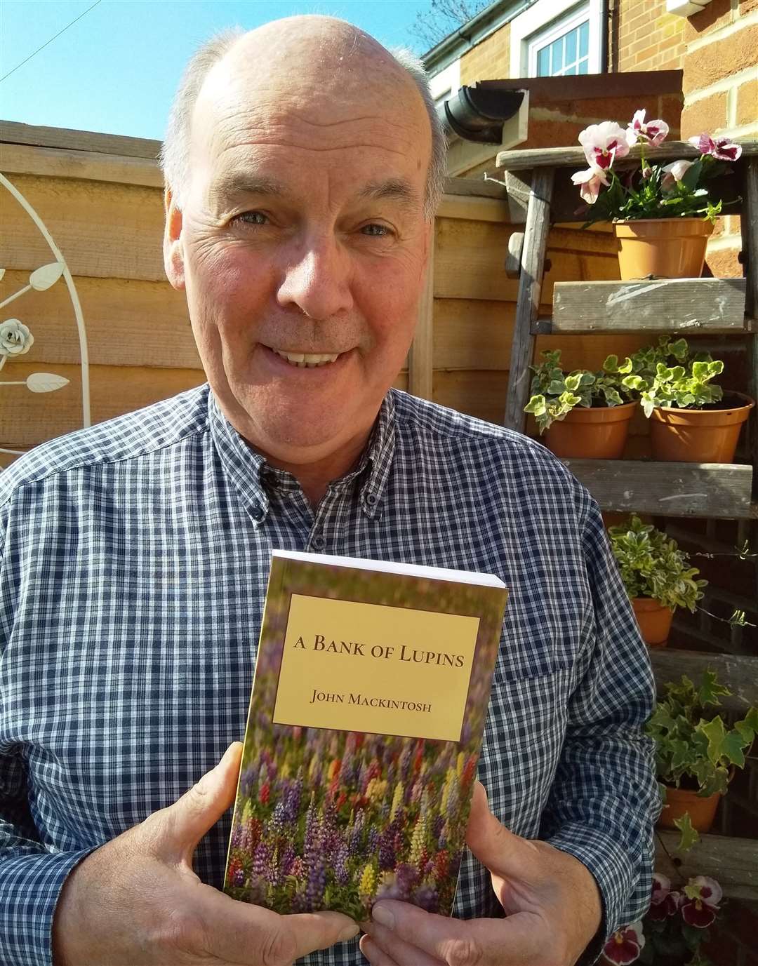 John with a copy of his first novel.