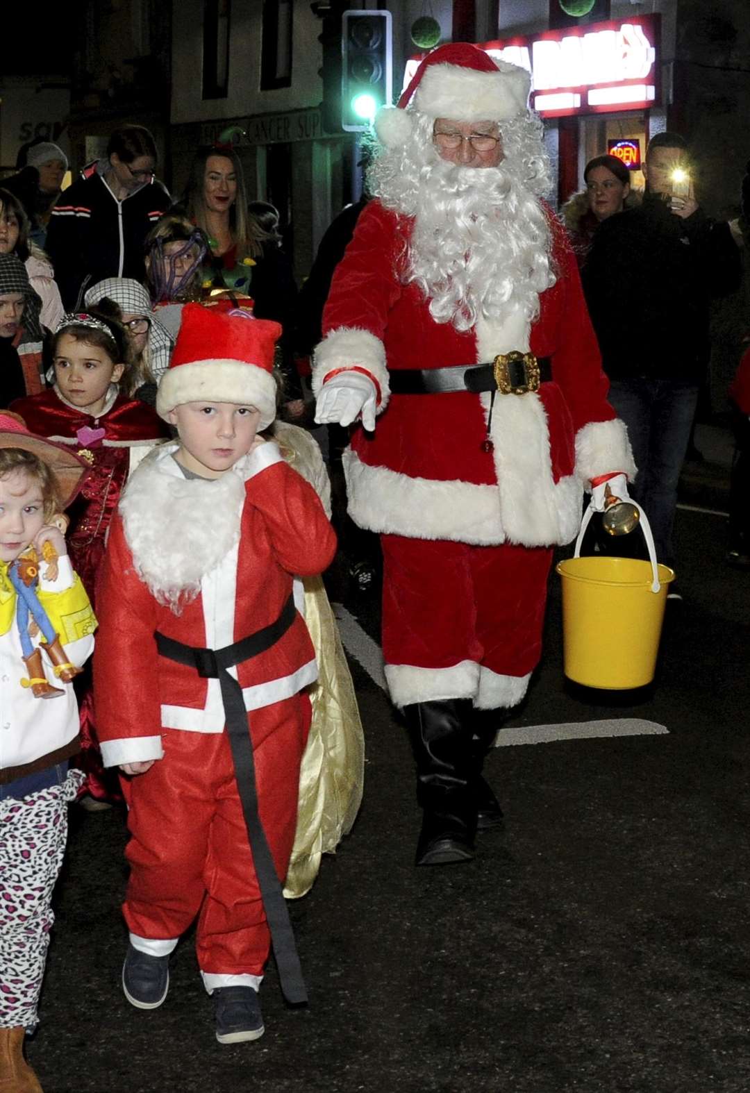 Santa leading the switch-on parade through the high street.