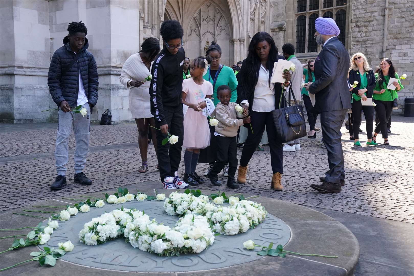 People place white roses in memory of the 72 victims of the Grenfell fire outside Westminster Abbey in London (Jonathan Brady/:PA)