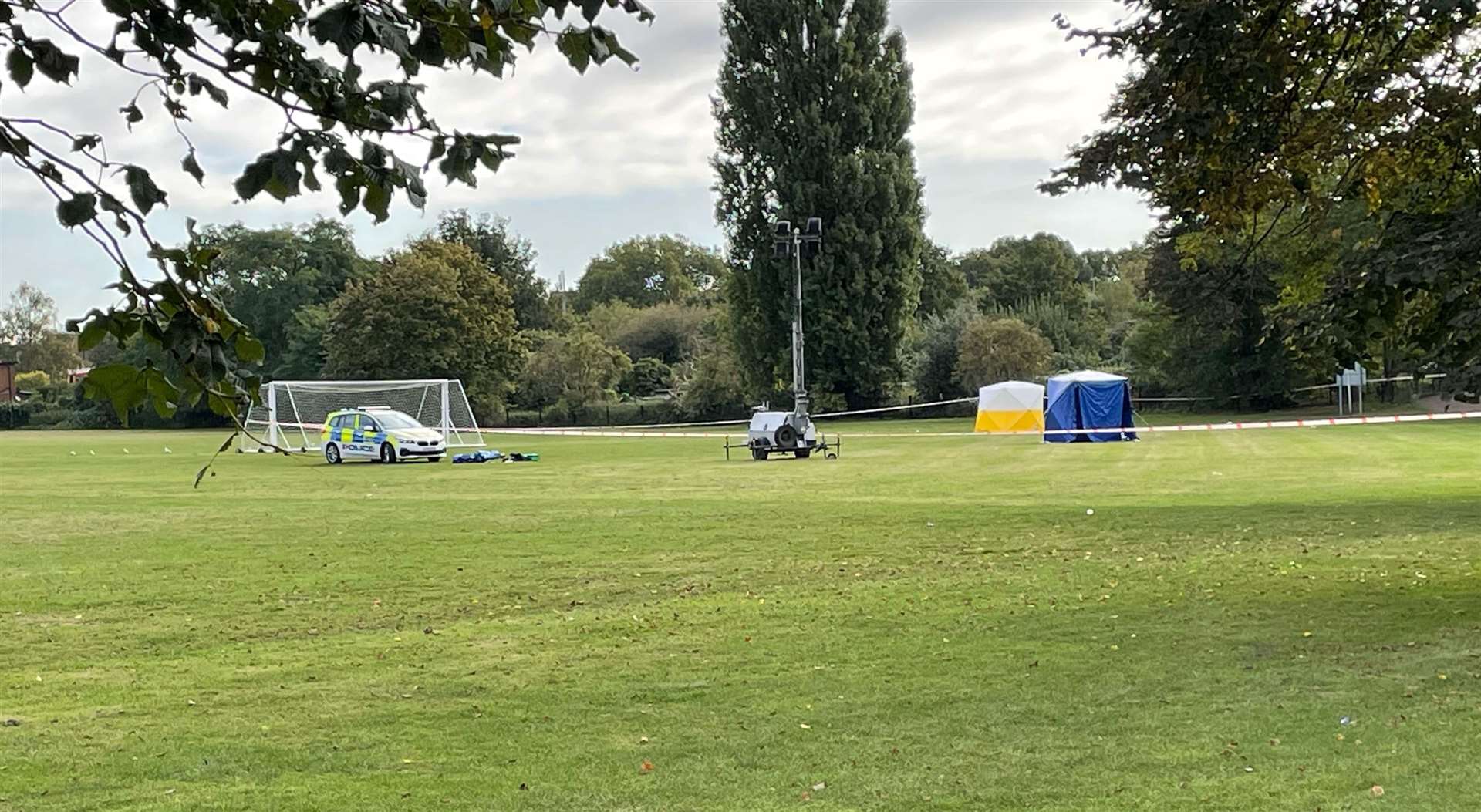 A police car and forensic tents at the scene on a playing field in Craneford Way, Twickenham, south-west London (Sophie Wingate/PA)