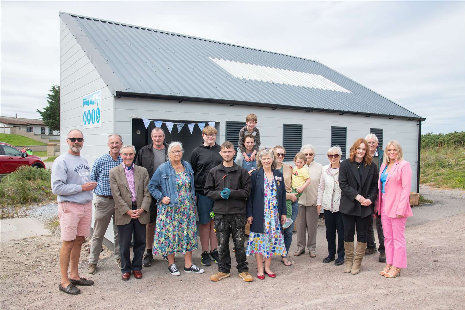 Members of the The Findhorn Village Conservation Company are joined by locals, funders and workmen at the opening of the refurbished west beach toilet block.