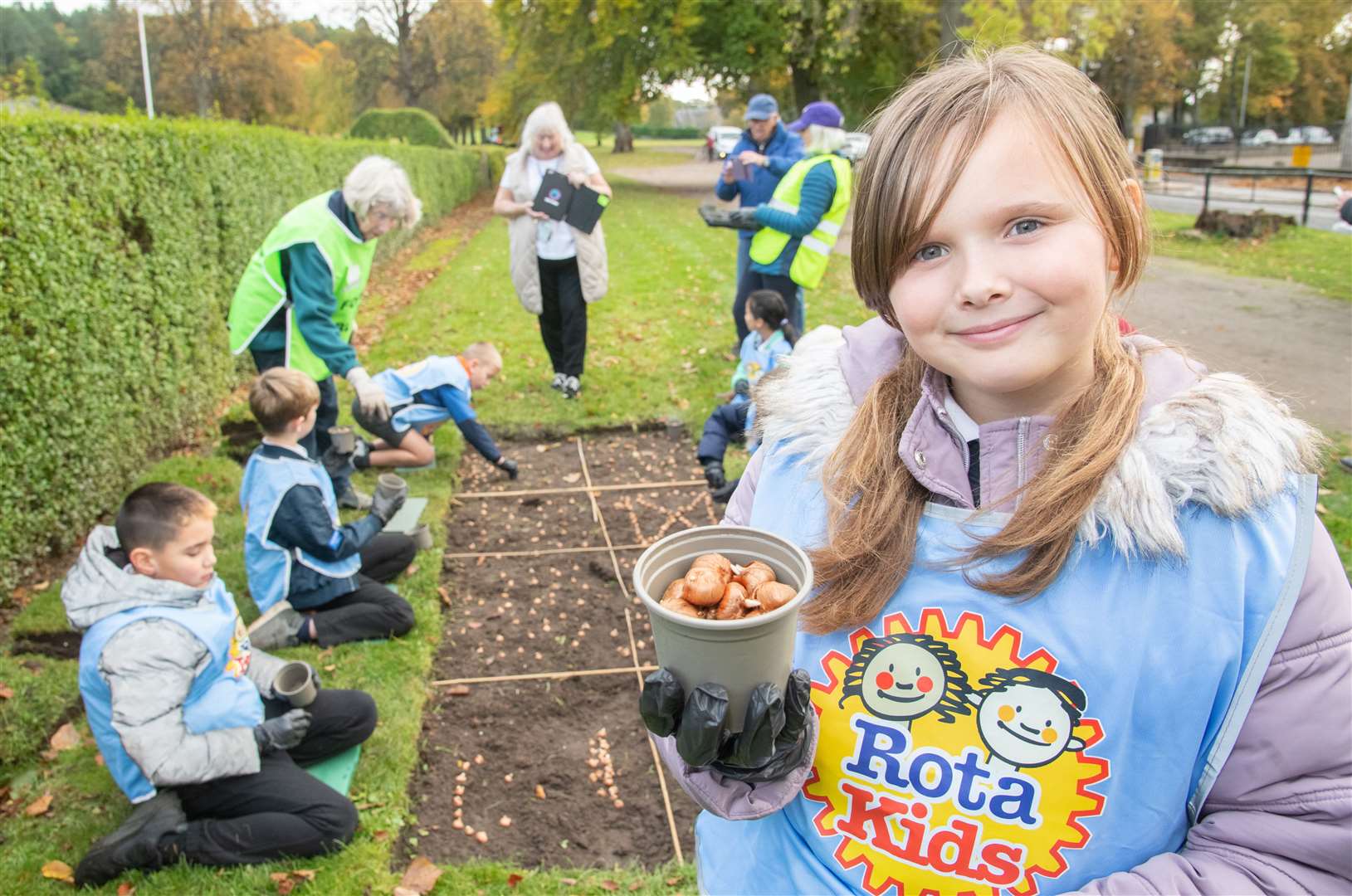 Elody Wallace with fellow pupils from Anderson’s Primary School in Forres plant crocus bulbs in Grant Park to raise awareness for polio.