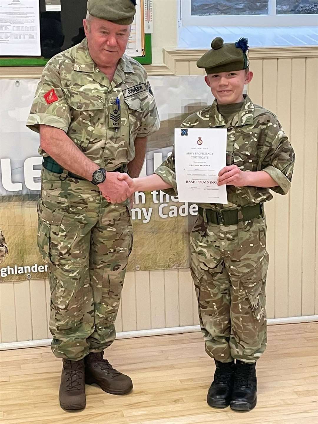 Cdt Travis Bremner receiving his Basic certificate and badge from SSI Cowieson.