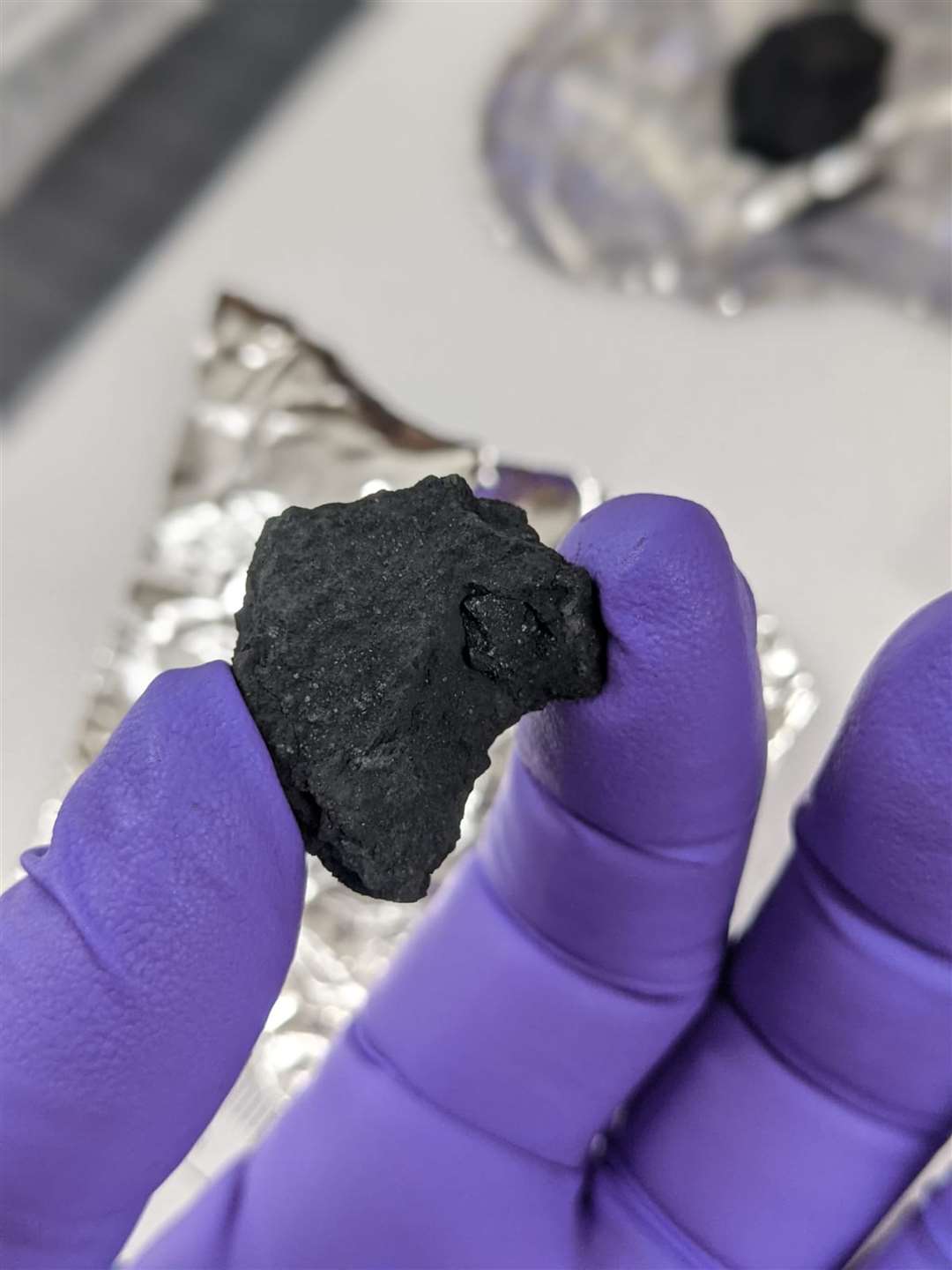 Fragment from a meteorite, likely to be known as the Winchcombe meteorite, which is an extremely rare type called a carbonaceous chondrite (Trustees of the Natural History Museum/PA)