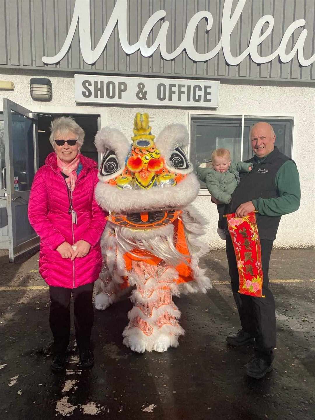 Maclean's directors Carol Shewan and Lewis Maclean with Lewis' grandson Rory and the Glasgow Hong Lok Lion.
