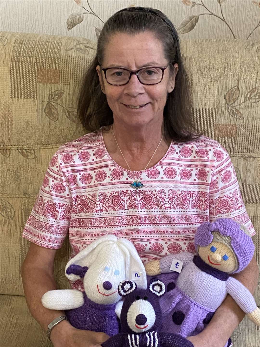 Rotarian Doreen McCaig and a few of the numbered knitted purple toys that are being hidden in 18 Forres shops.