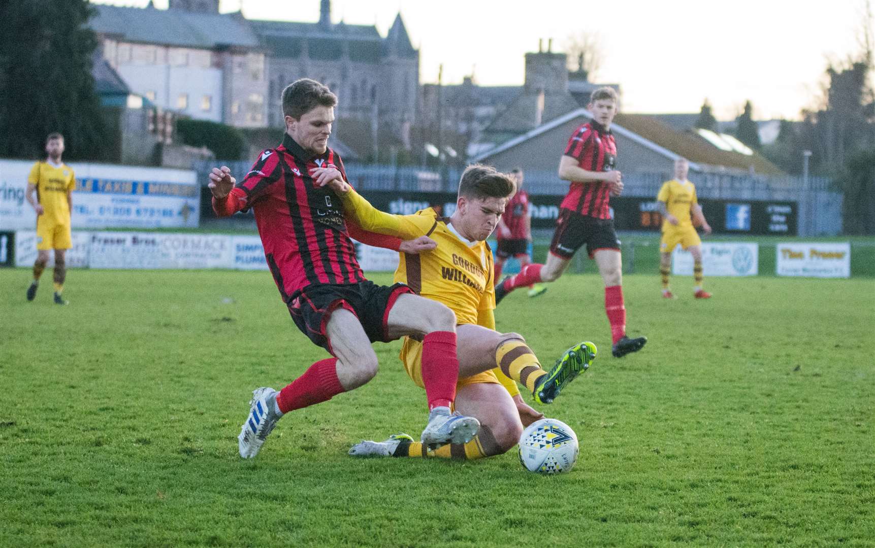 Inverurie's Sam Burnett is challenged by Declan Hughes. Picture: Becky Saunderson