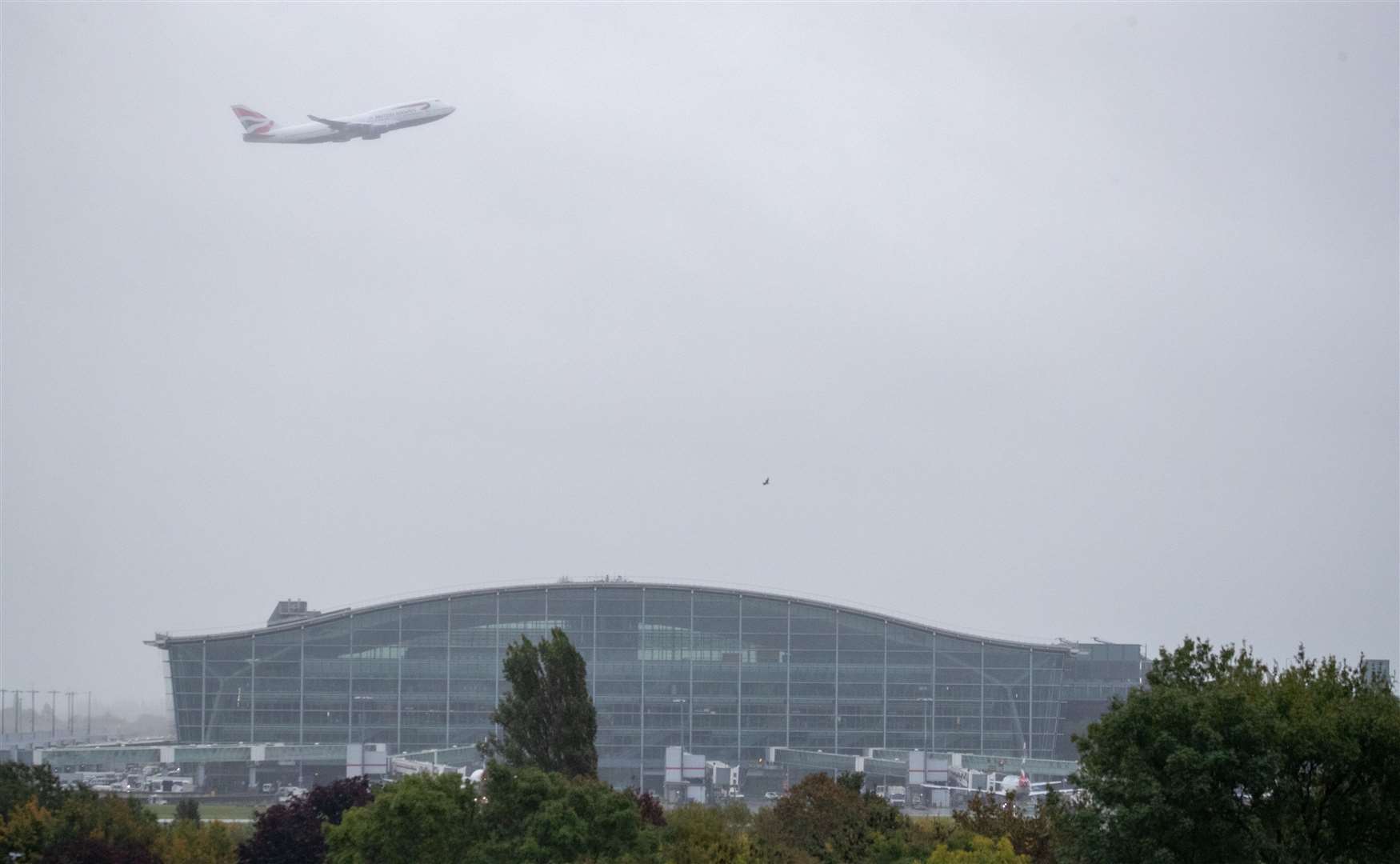 British Airways Boeing 747-400 aircraft, designated G-CIVY performs a fly past over Terminal 5 at Heathrow Airport (Andrew Matthews/PA)