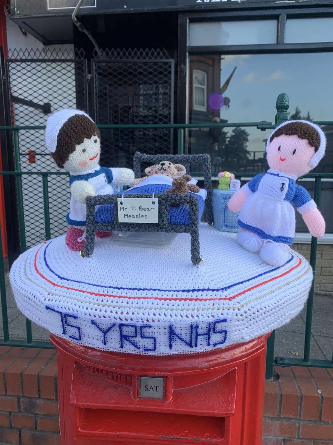 A postbox topper knitted by members of the knit and natter group in Kippax (Kathleen Jackson/PA)
