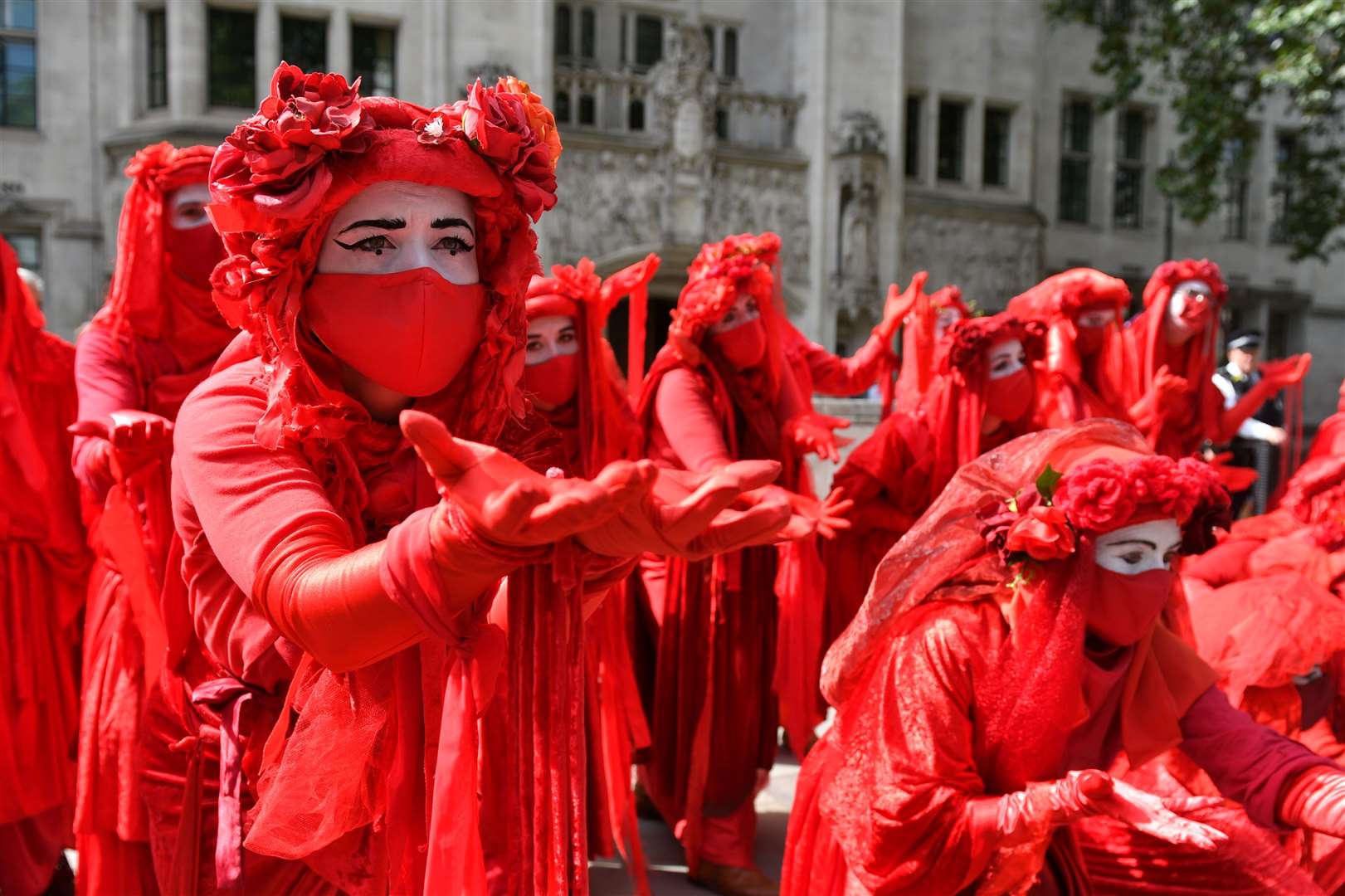 Members of the Red Brigade take part in an Extinction Rebellion demonstration (Dominic Lipinski/PA)