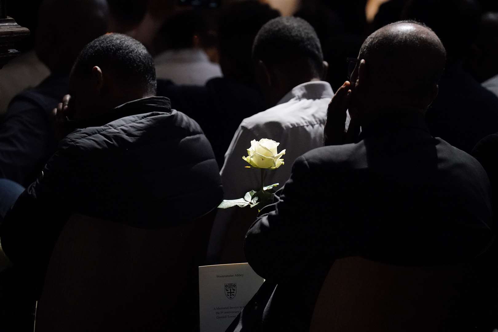 Attendees were given white roses in remembrance of those who died (Jonathan Brady/PA)