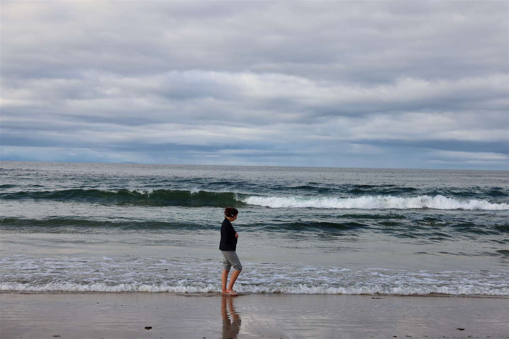 Alone with her thoughts at Hopeman beach.