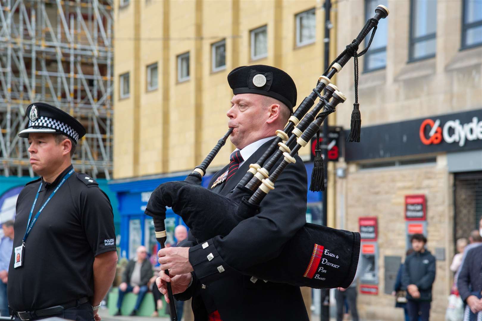 Pipe Major Peter Criagmile plays during the VJ Day service at Elgin's Plainstones. Picture: Daniel Forsyth.
