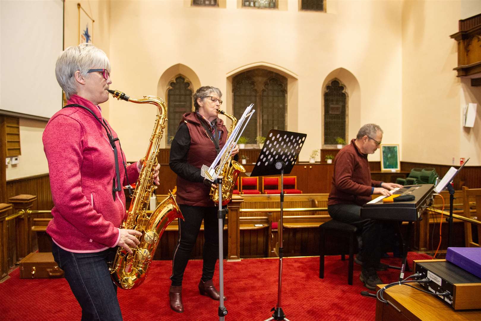 Linda Ross, Lorna Creswell and Chris Neal rehearsing ahead of the modern church service. Picture: Daniel Forsyth
