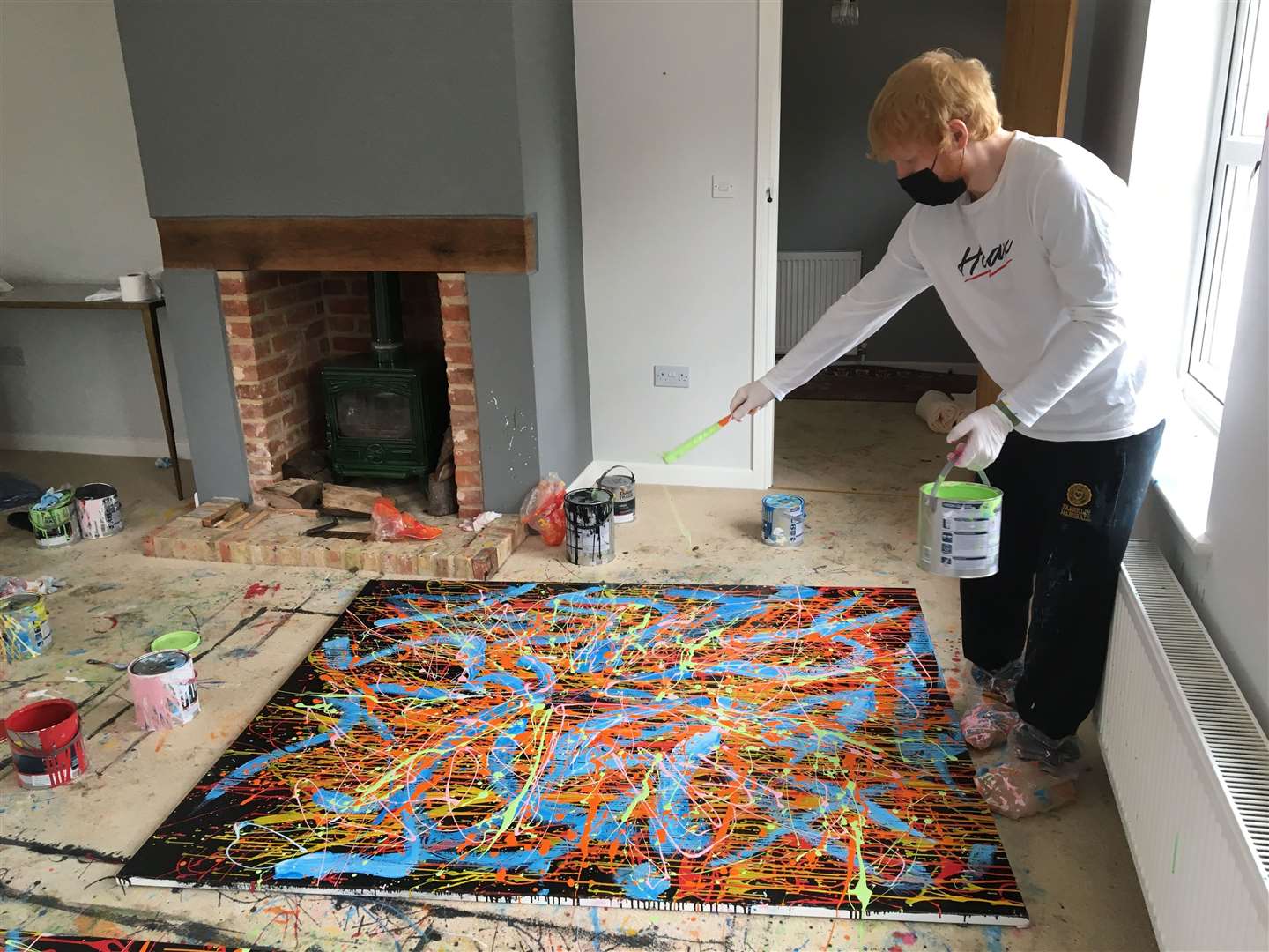 Ed Sheeran working on a separate painting (Ed Sheeran: Made In Suffolk Legacy Auction/PA)