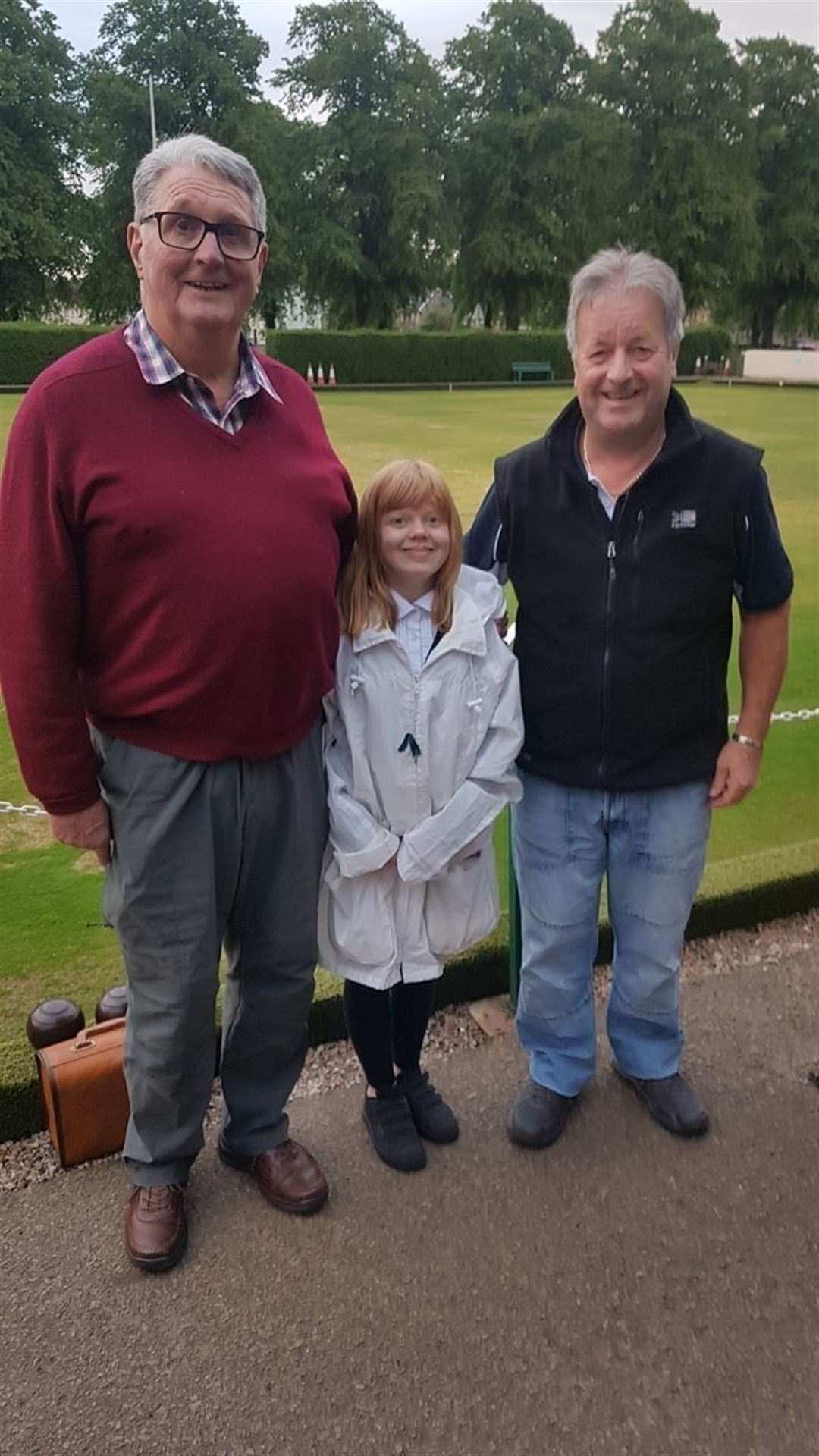 Young Forres bowler Caitlin Dustan with Derek Crosby and John Ross.