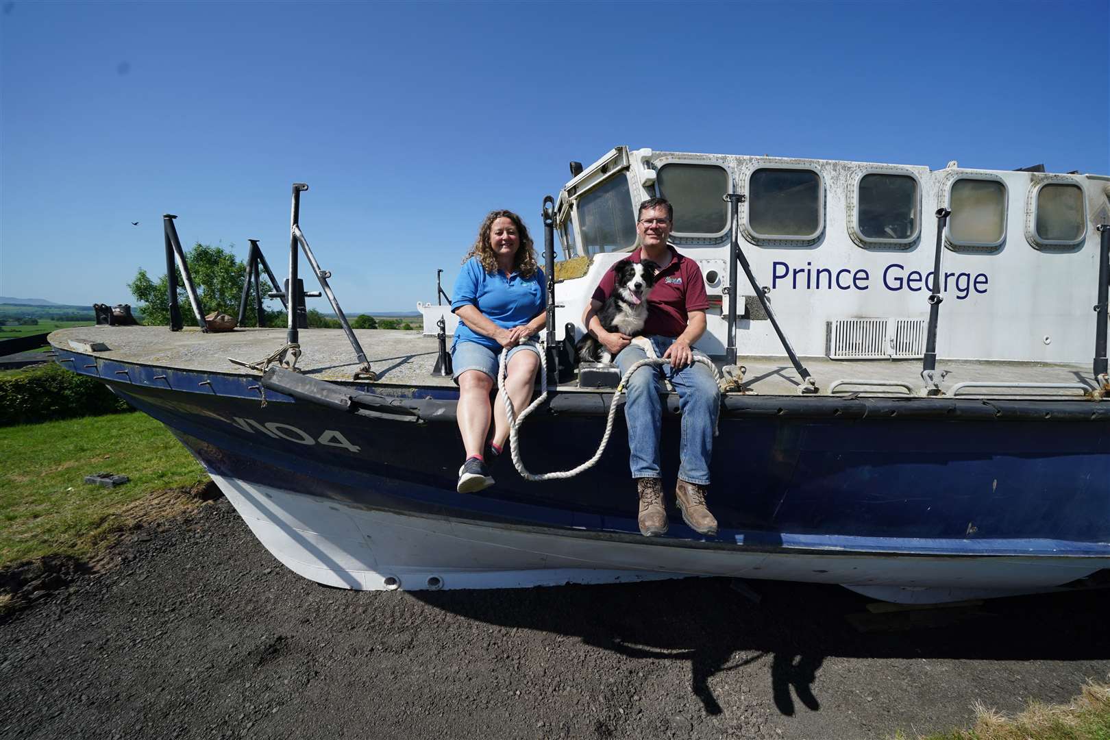 Martyn Steedman and Louise Cross with their dog Jaffa aboard the former RNLI lifeboat (Andrew Milligan/PA)