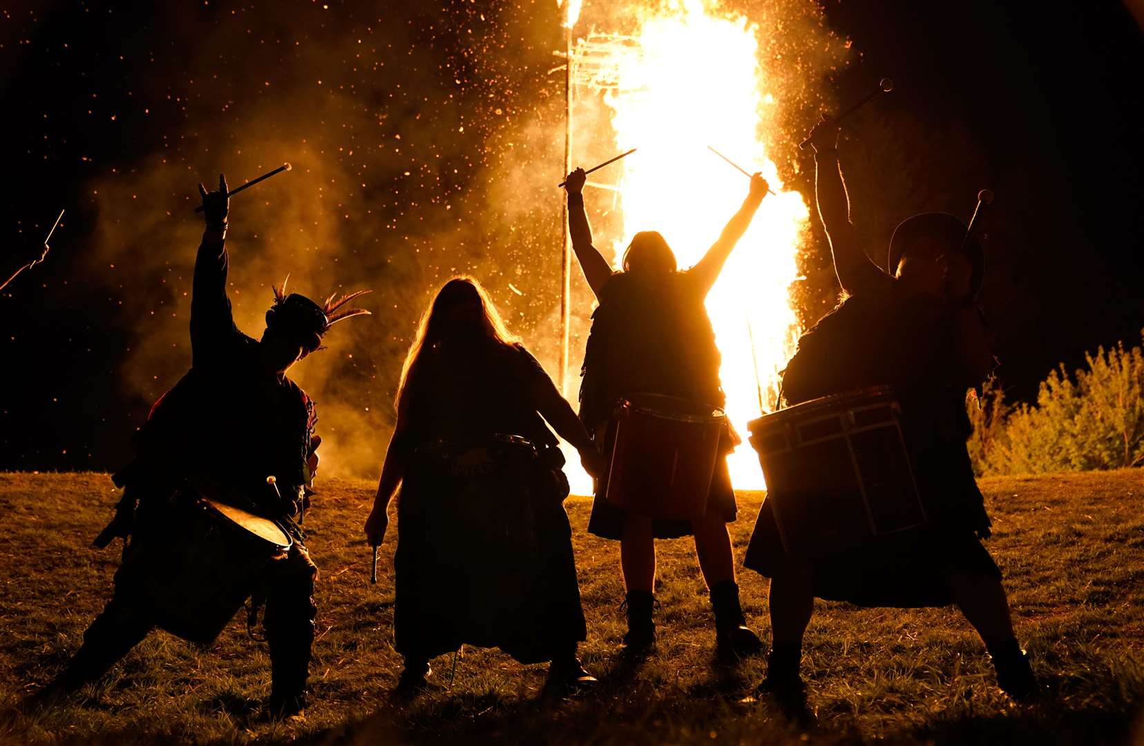 Members of the Pentacle Drummers perform in front of a burning wicker man during the Beltain Festival at Butser Ancient Farm in Waterlooville, Hampshire, in April (Andrew Matthews/PA)