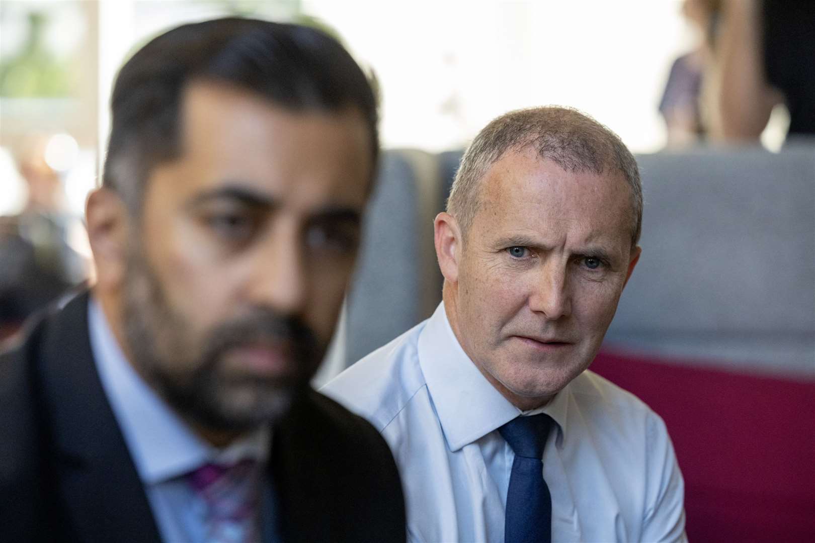 Michael Matheson, right, was supported by First Minister Humza Yousaf to continue in the role when the charges first emerged (PA)