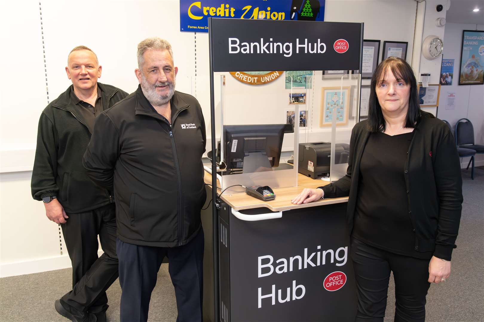 Postmaster Paul McBain, Bank of Scotland customer service manager Paul Grant and counter clerk Sylvia McKenzie at the temporary hub in Moray Firth Credit Union.