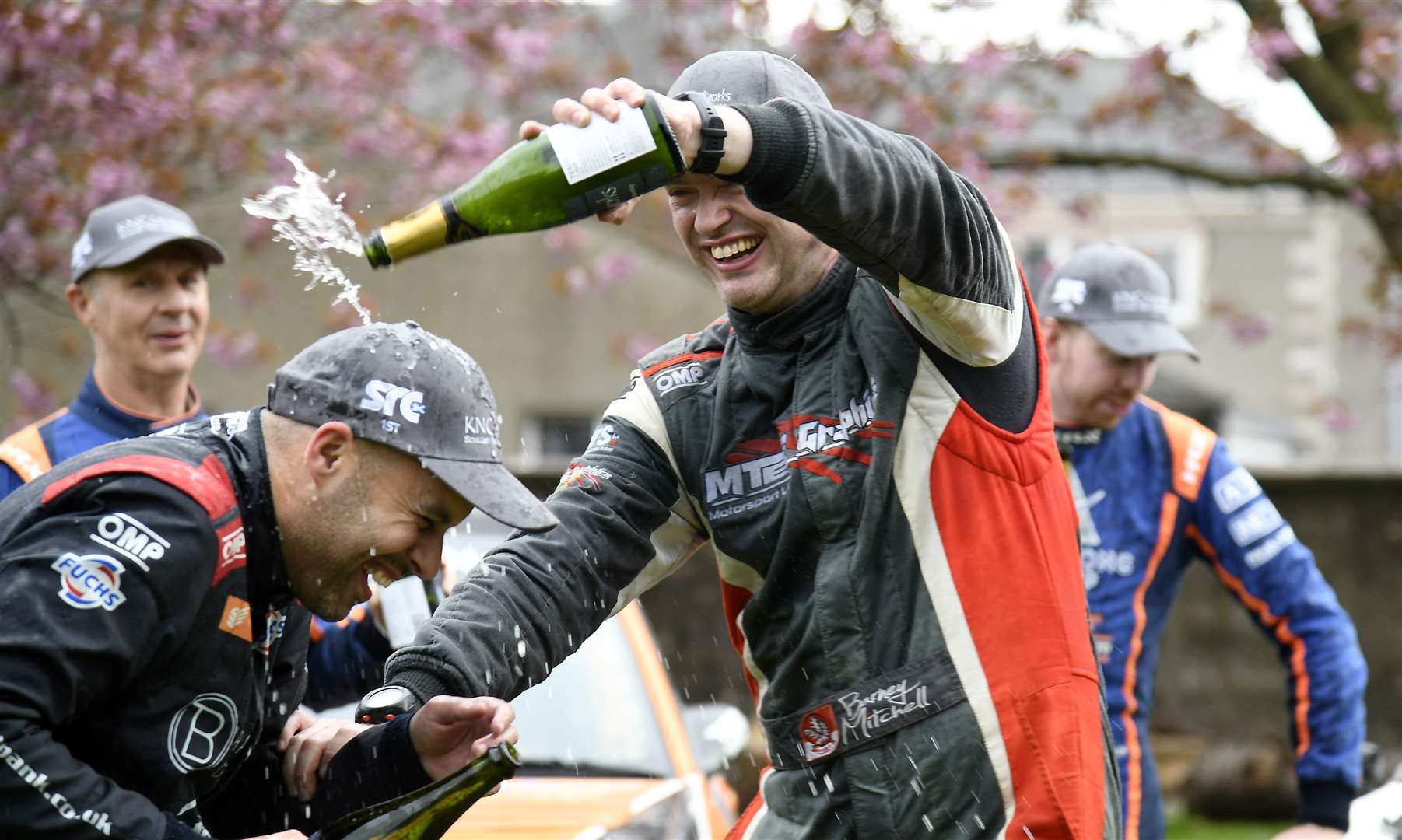 Bogie and Mitchell spray the champagne. Picture: Becky Saunderson..