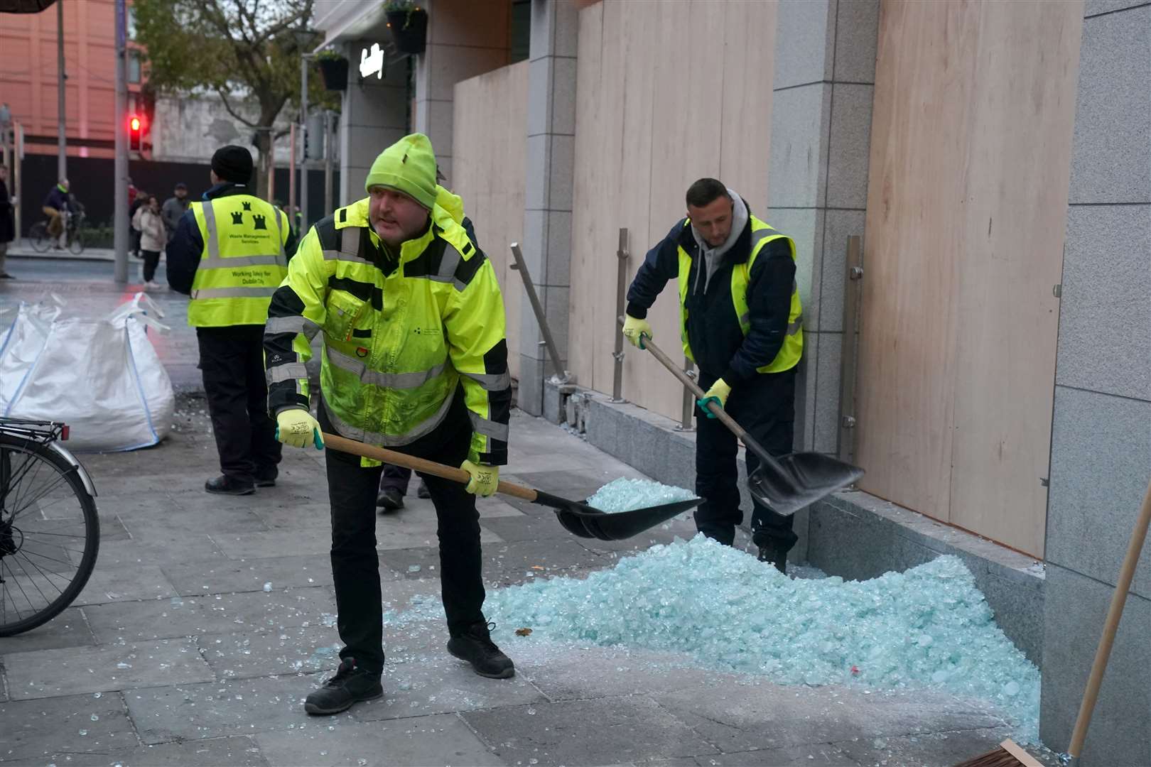 Workers clean up the debris from broken windows of the Holiday Inn Express on Cathal Brugha Street, in Dublin (Brian Lawless/PA)