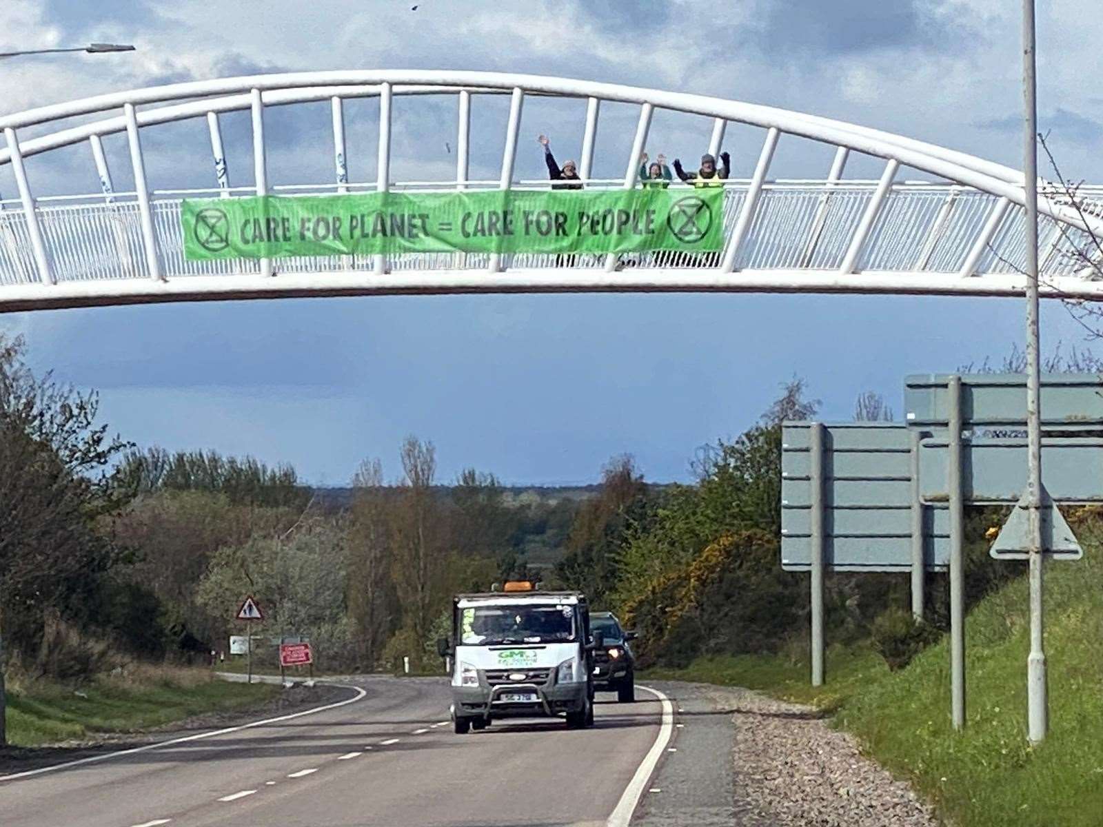 Environmental campaigners dropping their banner to raise awareness of climate change.