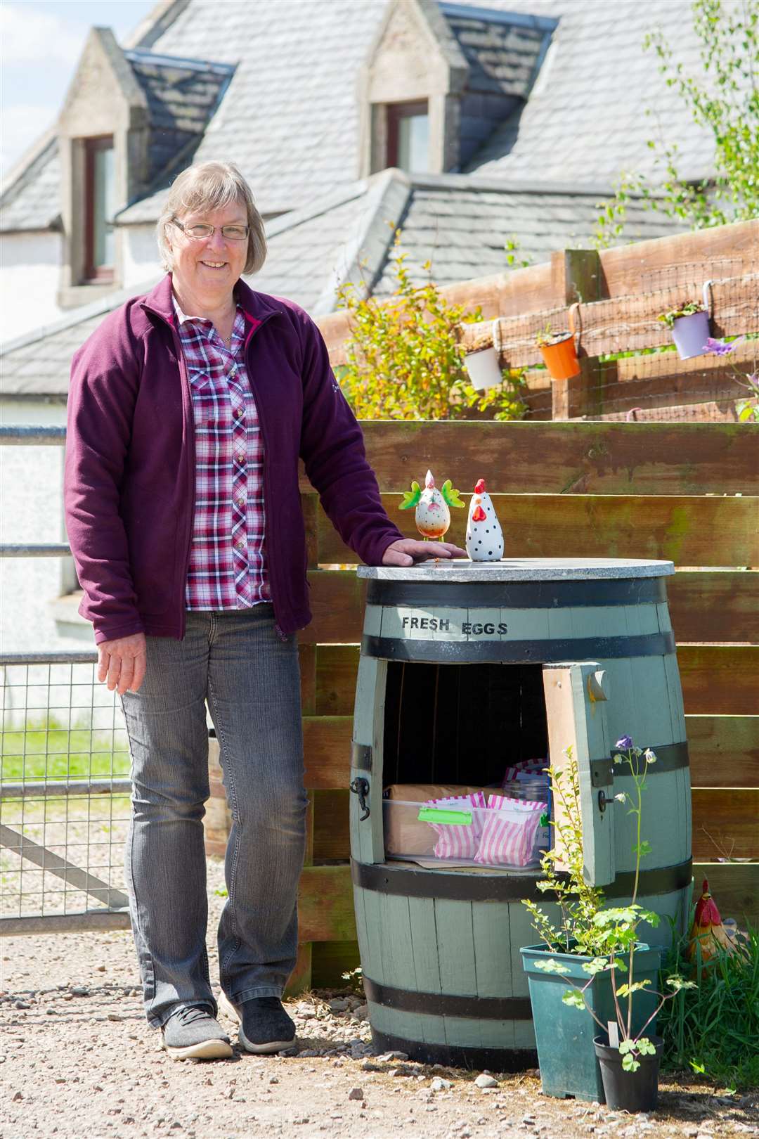 Jackie is selling produce including jam, cakes and tablet from a barrel at the end of her garden.