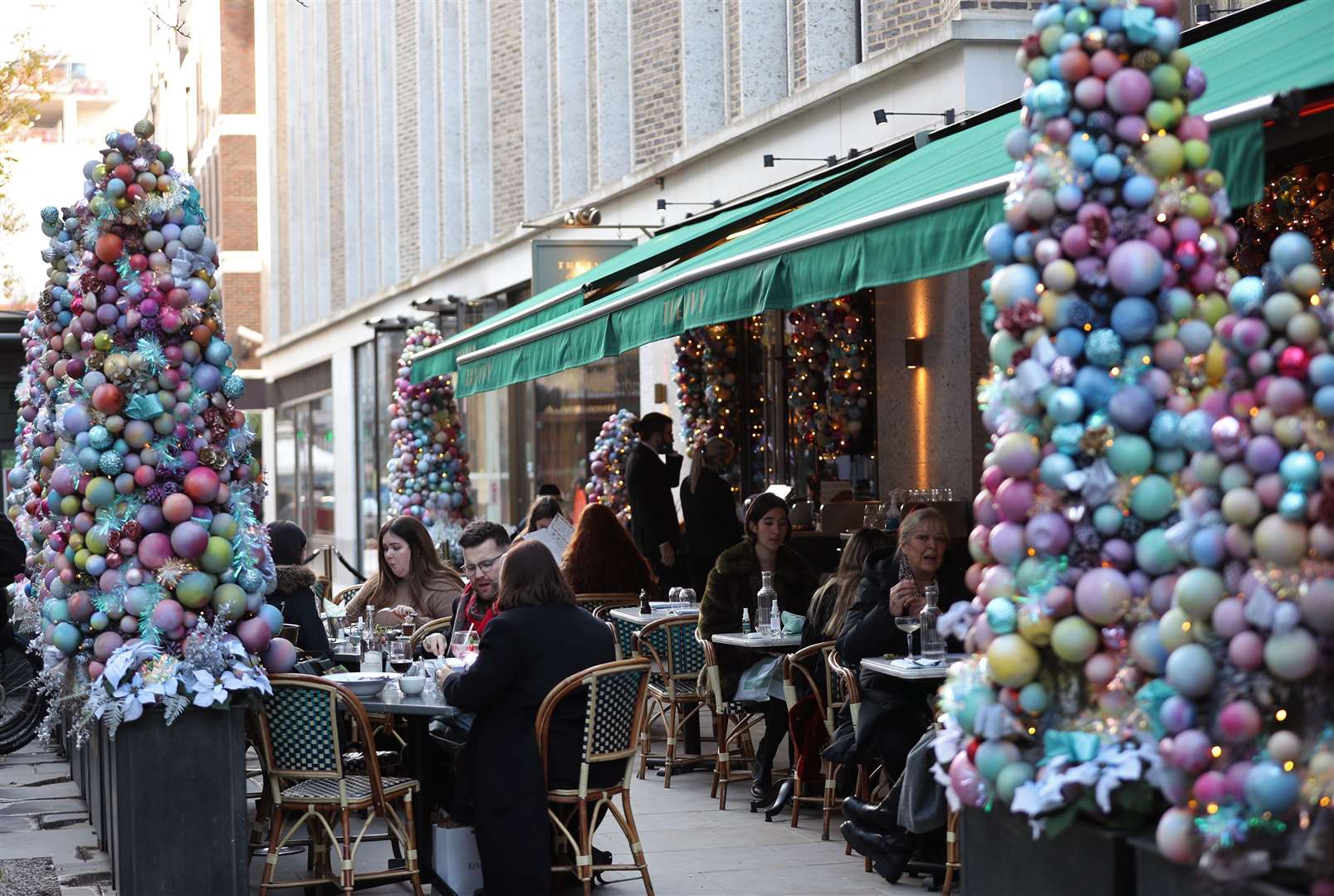 People dining on outdoor tables at a restaurant in Soho, London (Yui Mok/PA)