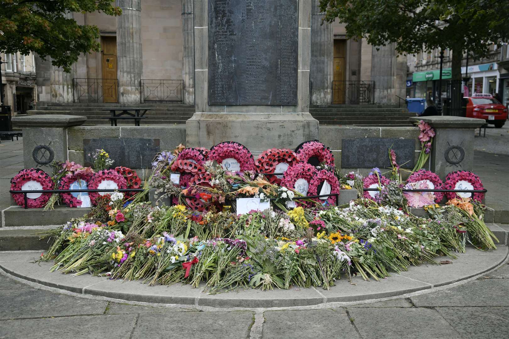 The many floral tributes outside the front of St Giles. Picture: Beth Taylor.