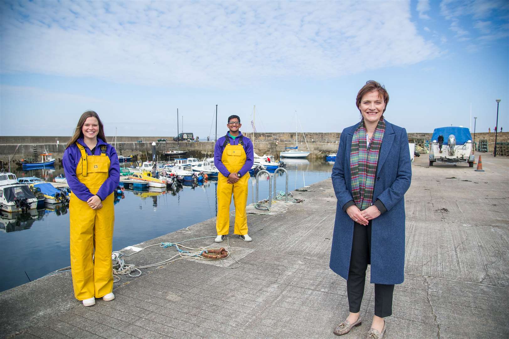 Gordonstoun principal Lisa Kerr with pupils Isabel Edge and Mayon Wiliams at Hopeman Harbour. Picture: Becky Saunderson.
