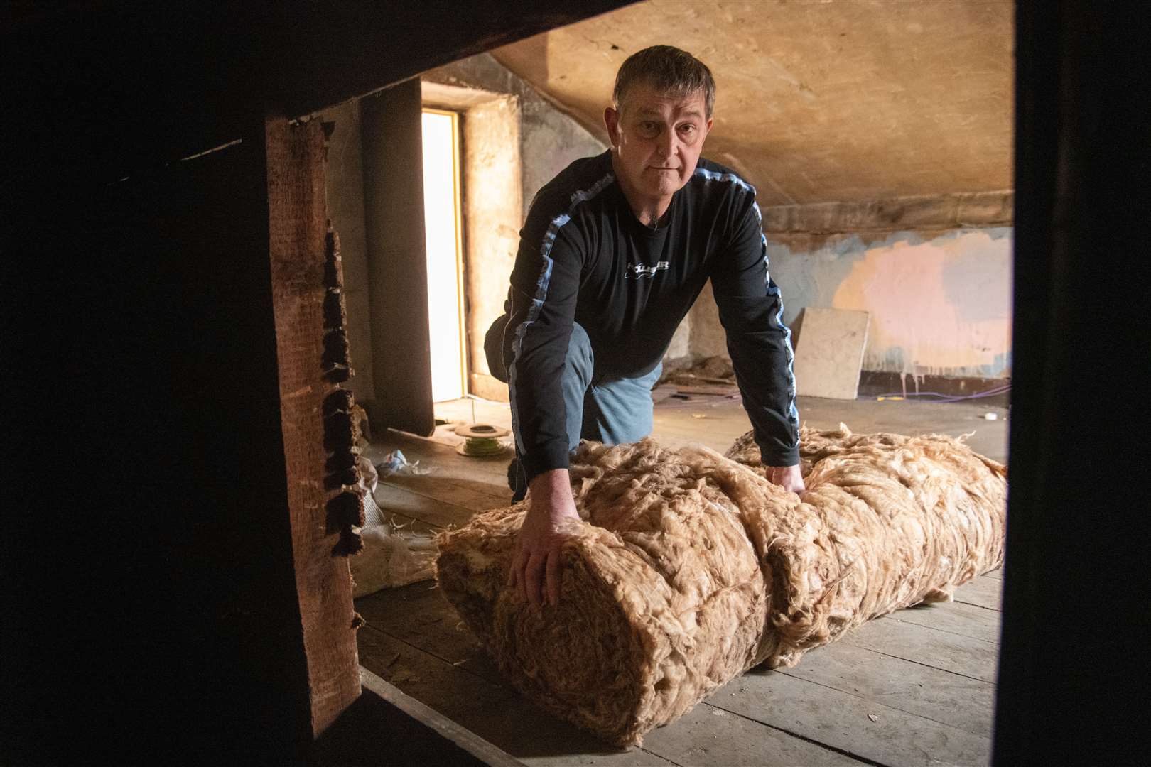 Nick Clark and Forres Area Community Trust will be rolling out new insulation material in the town hall eves. Picture: Daniel Forsyth