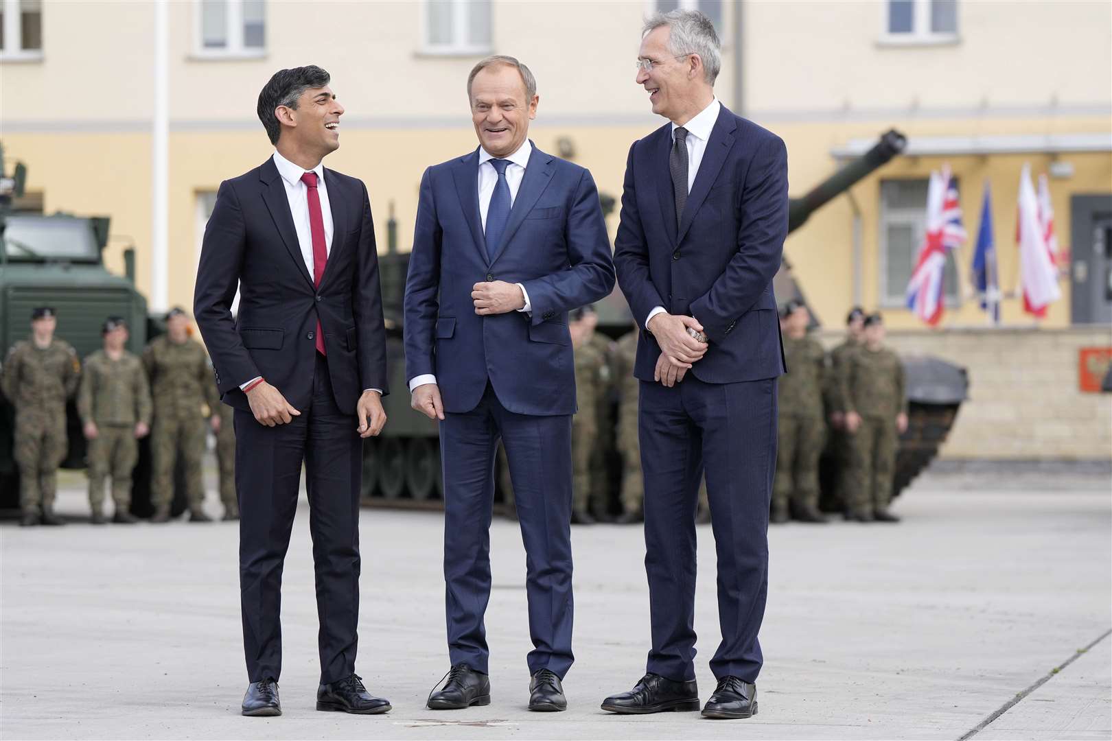 Prime Minister Rishi Sunak, left, with Poland’s Prime Minister Donald Tusk, centre, and Nato Secretary-General Jens Stoltenberg at a barracks in Warsaw (Alistair Grant/PA)