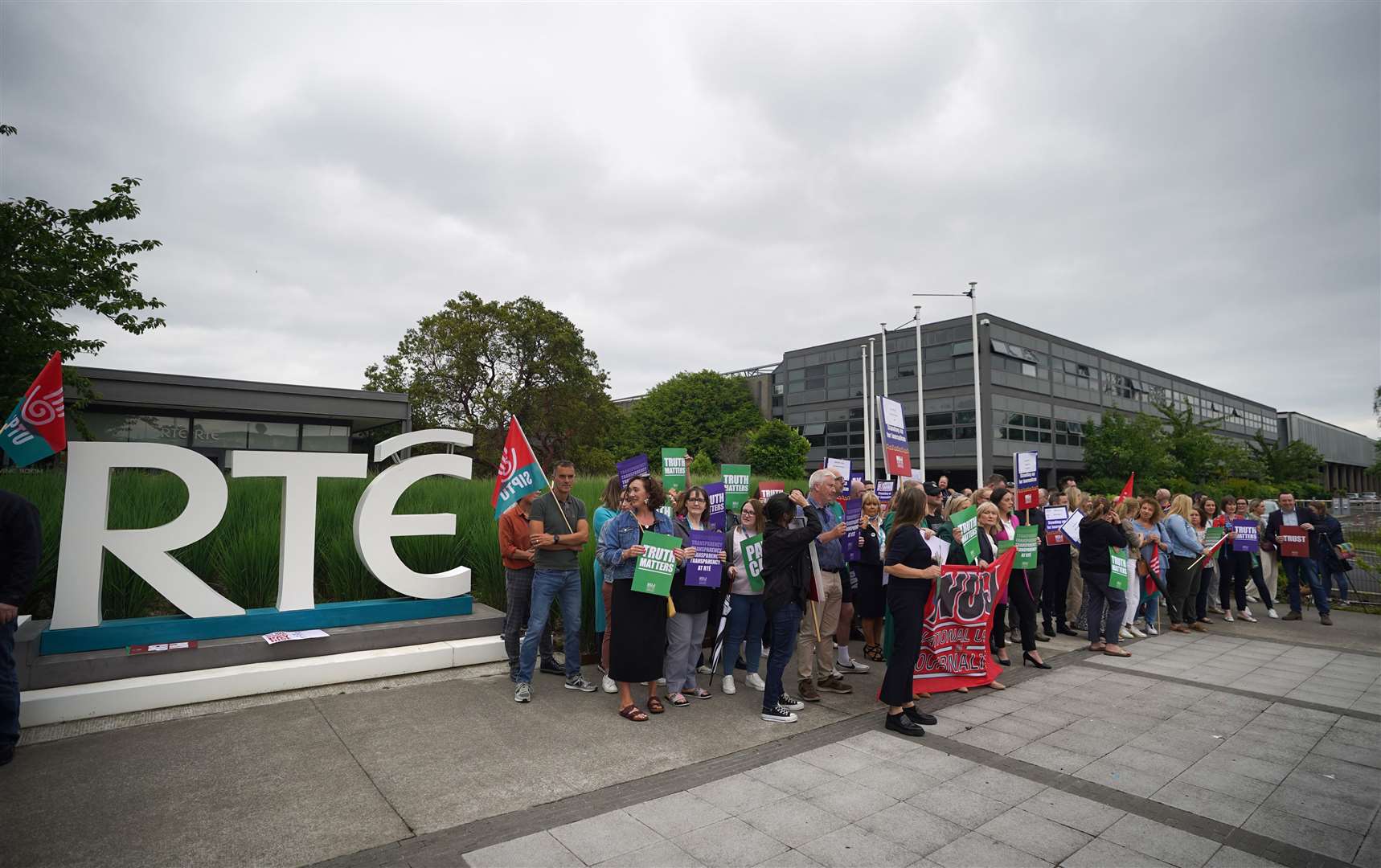 Members of staff from RTE take part in a protest at the broadcaster’s headquarters in Donnybrook, Dublin (Niall Carson/PA)