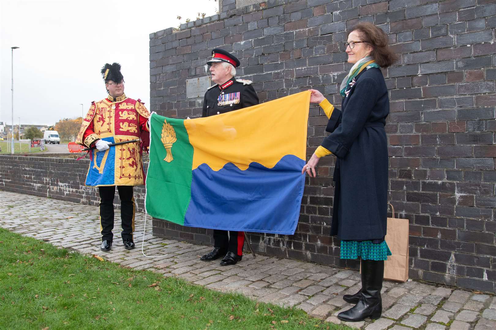 From left; Philip Tibbetts (Lyon Court Vexillologist for Scotland), Lord Lieutenant of Moray Seymour Monro and Vice Lord Lieutenant of Moray Nancy Robson unveil the Moray flag...The Moray flag is unveiled during a ceremony outside the Elgin Town Hall. ..Picture: Daniel Forsyth..