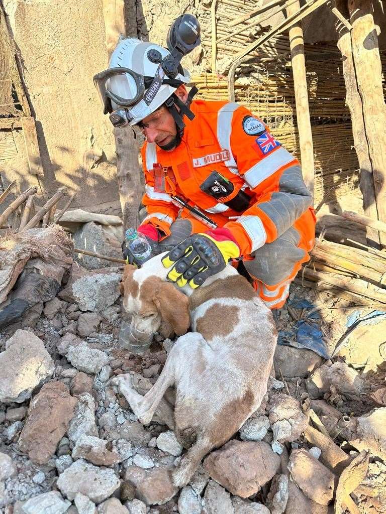 Firefighter Jamie Muddle poured water for the dog to drink after the team pulled her from the rubble (KFRS/PA)